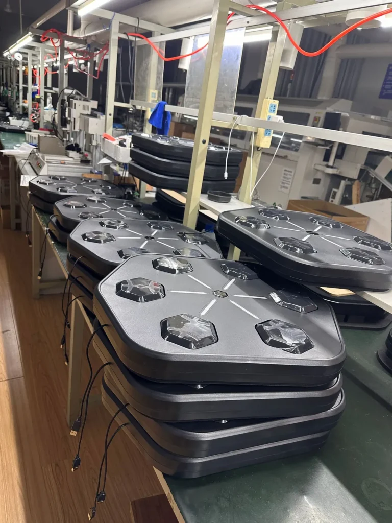 Stacks of six-target smart music boxing machines on the manufacturer’s assembly line before packing
